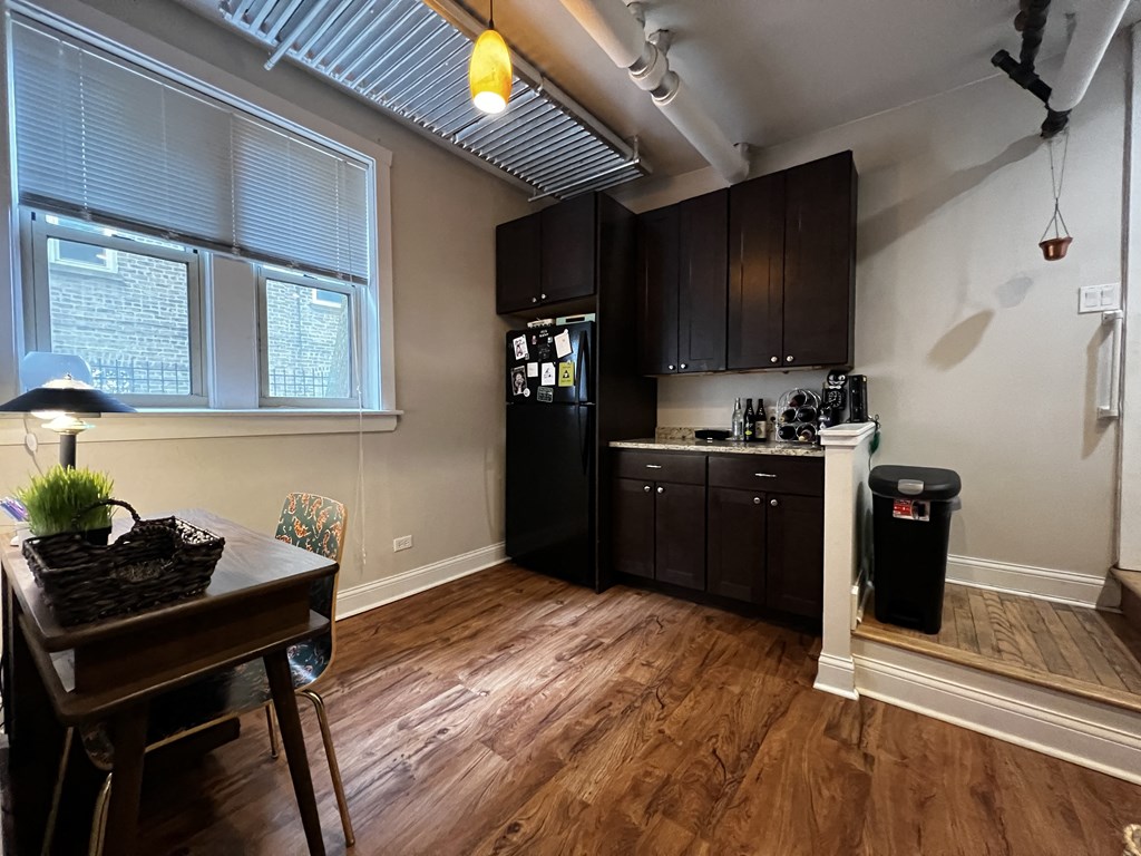 a kitchen and dining room with a table and a refrigerator
