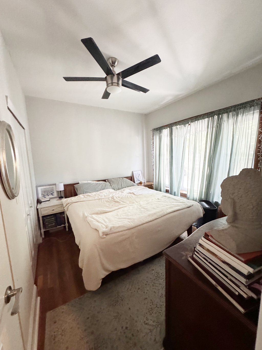 a bedroom with a bed and a ceiling fan