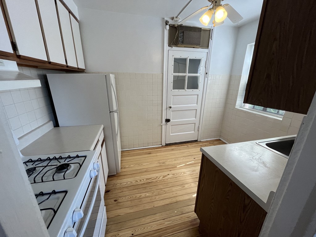 a small kitchen with a stove and a refrigerator