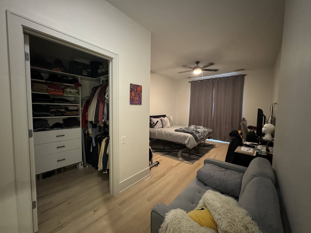 a living room with a closet and a couch and a bed