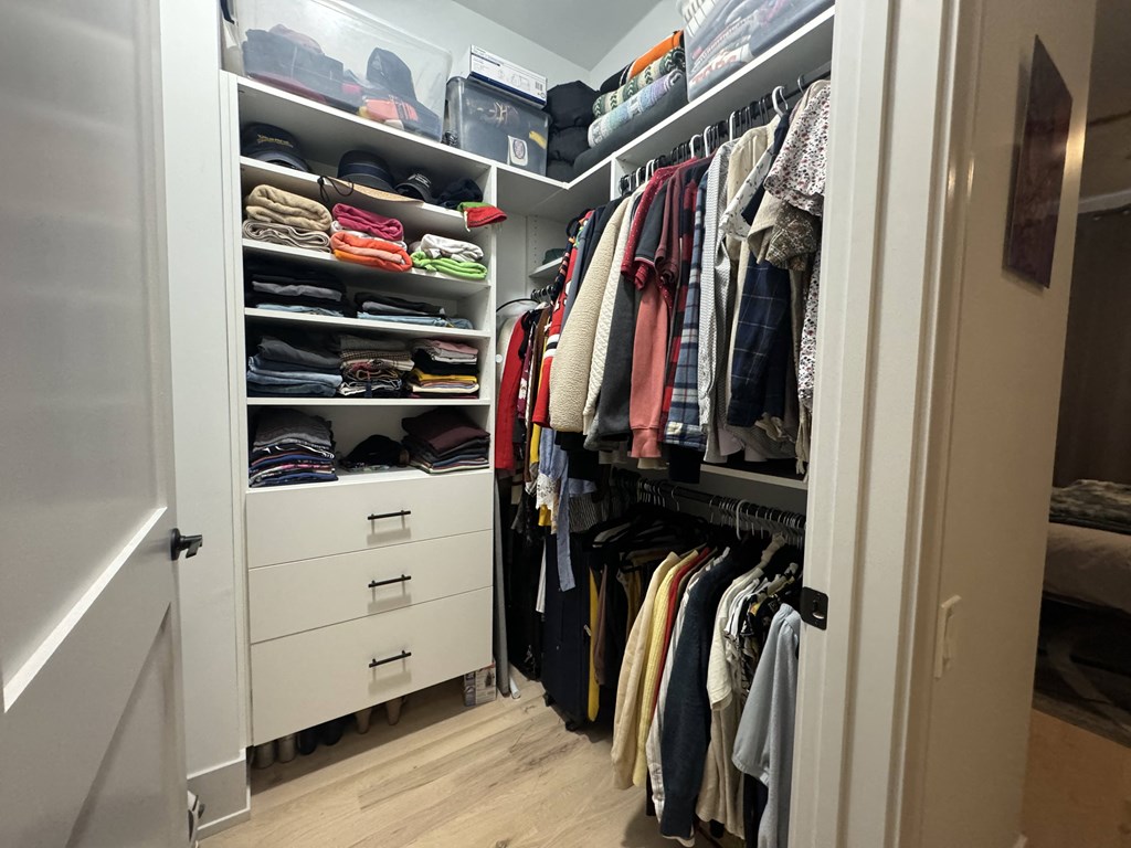 a closet with a lot of clothes in it