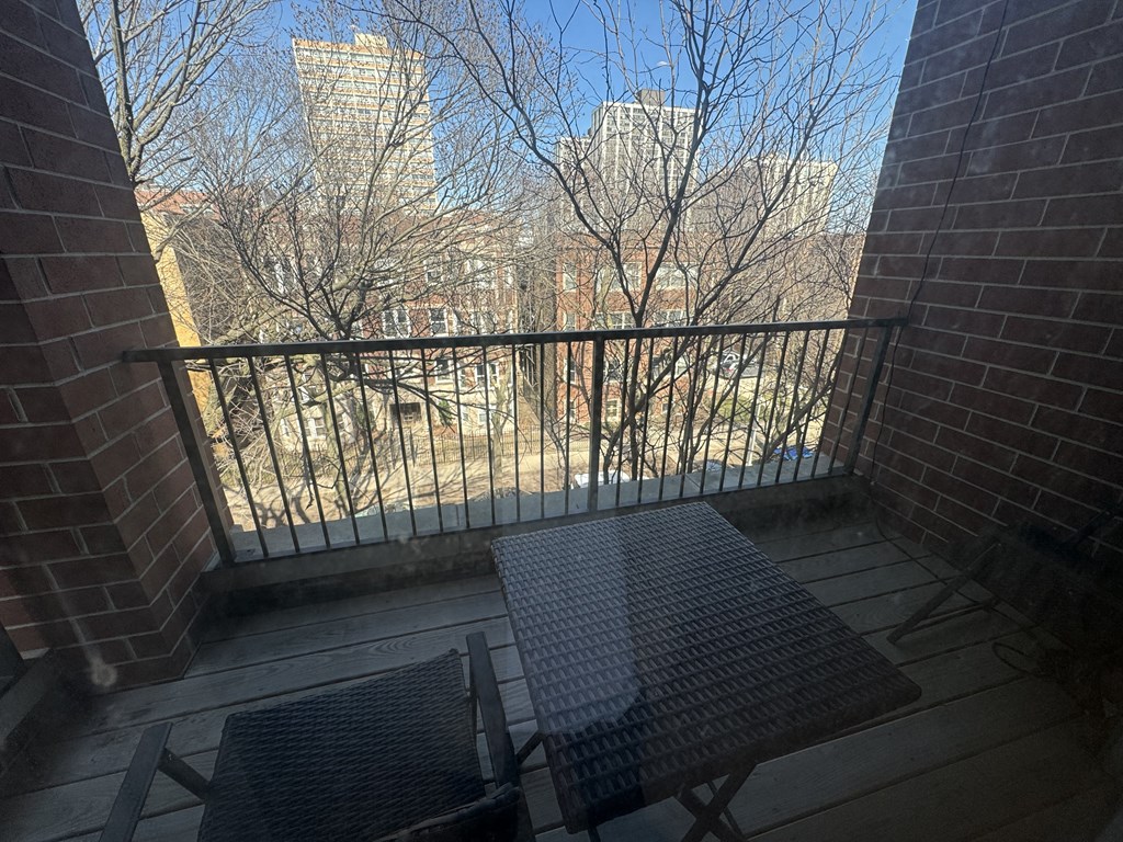 a balcony with a table and a view of the city
