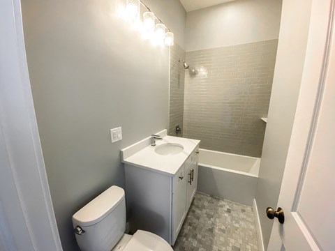 A white toilet sits next to a sink in a bathroom.