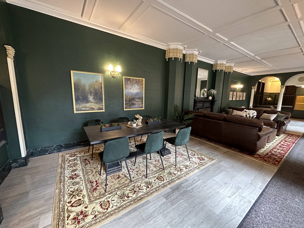 a dining room with green walls and a table and chairs