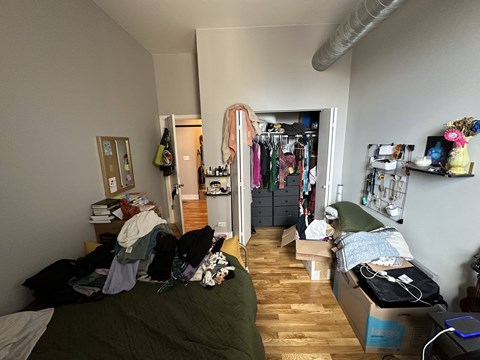 A room with a bed, a wardrobe and a desk.