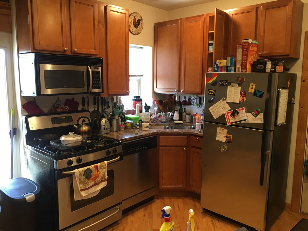 A kitchen with a stove, oven, and refrigerator.