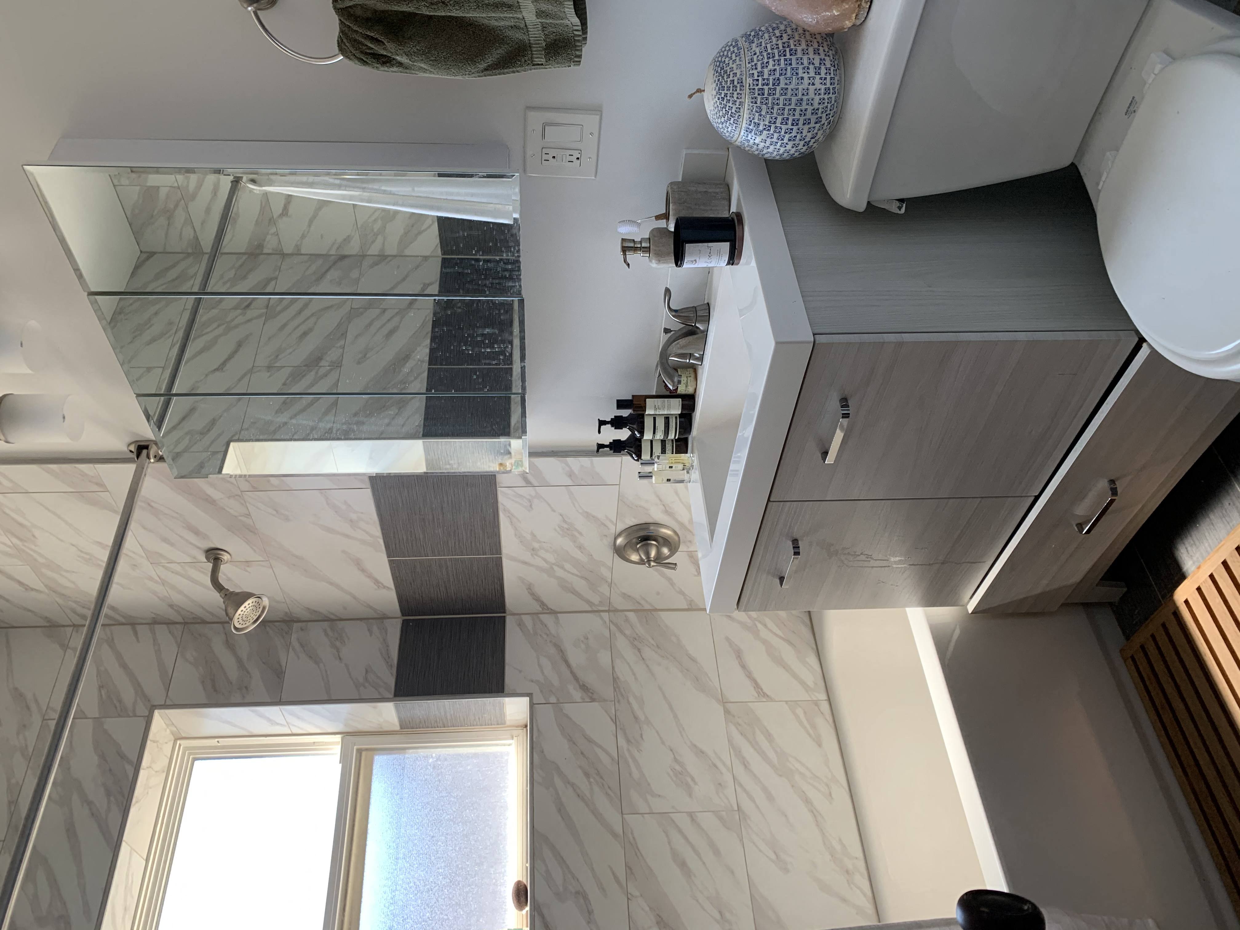 a bathroom with a shower and a sink and a toilet