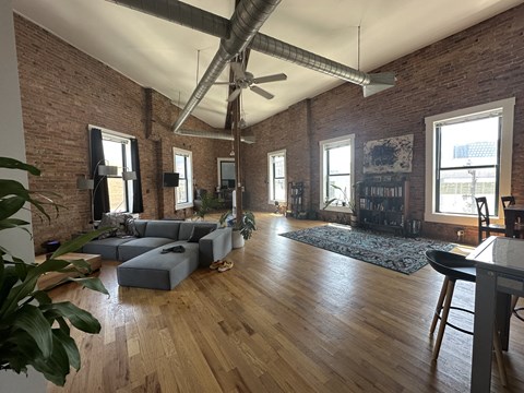 a living room with a couch and a ceiling fan