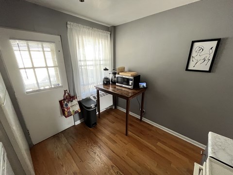 A kitchen with a wooden table and a white fridge.