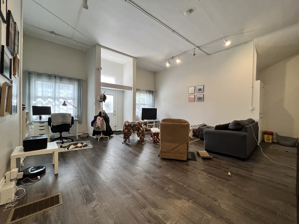 a living room with couches and chairs and a tv