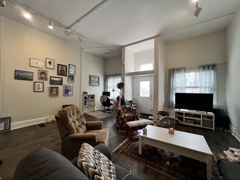 a living room with couches chairs and a television