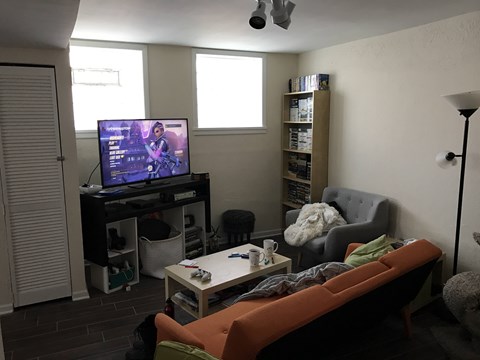 A living room with a television and a couch.