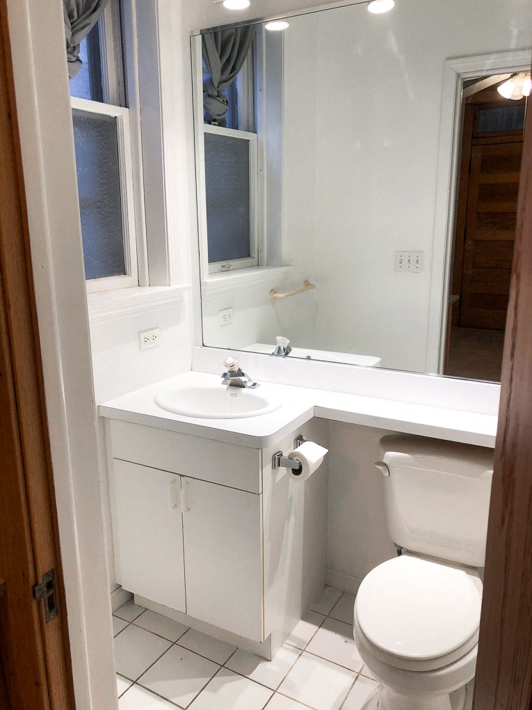 a small bathroom with a toilet sink and mirror