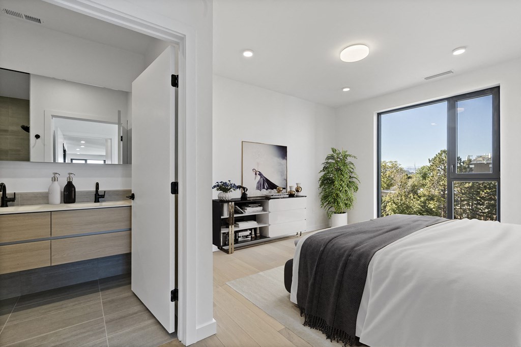 a bedroom with a bed and a large window