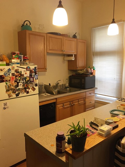 a kitchen with a counter top and a refrigerator