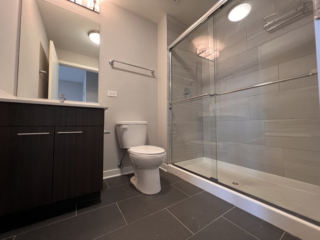 a bathroom with a toilet and a glass shower