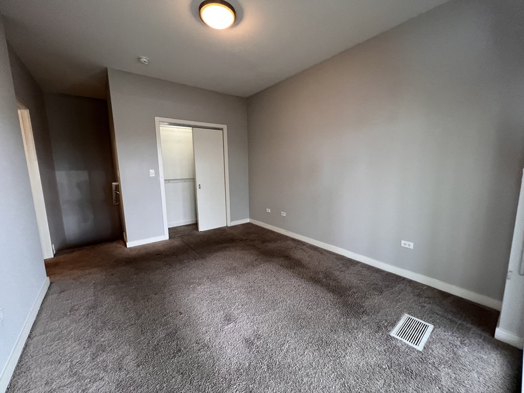 a empty living room with gray walls and carpet