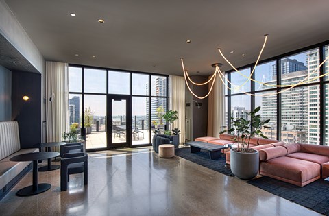 A modern living room with a large window overlooking the city.