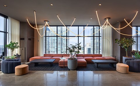 A modern living room with a large window overlooking the city.