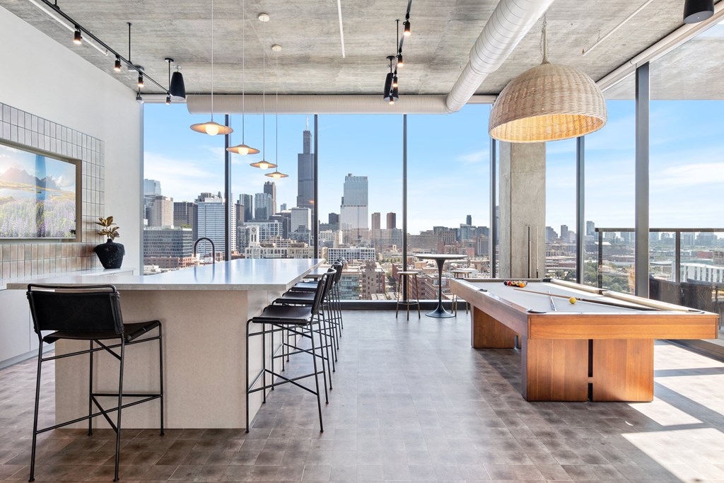 a game room with a pool table and a view of the chicago skyline