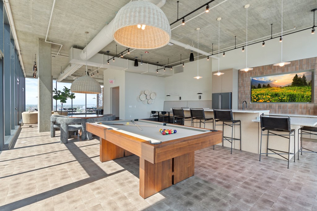 a games room with a pool table and a bar