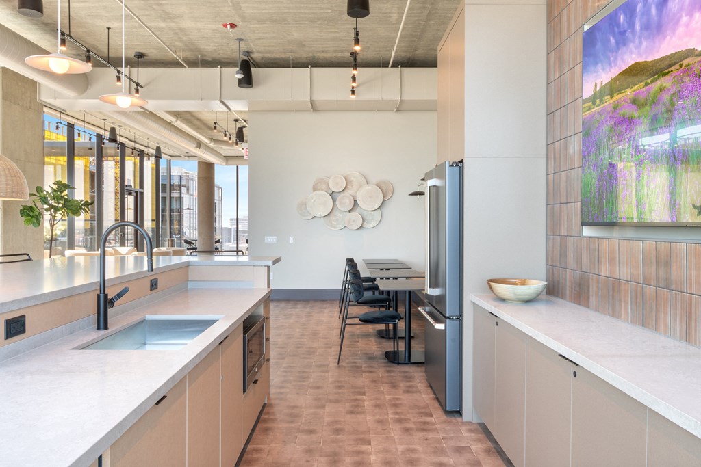 a kitchen with white countertops and stainless steel appliances