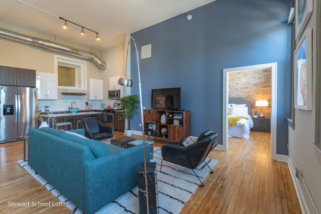 a living room with a blue accent wall and a blue couch