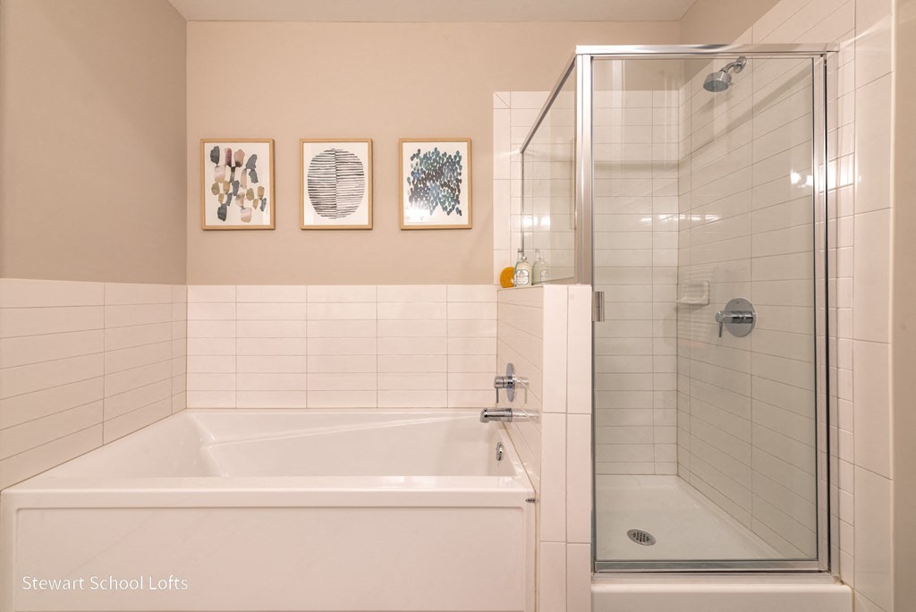 a bathroom with a tub and a shower