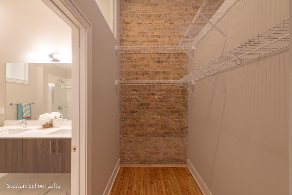 a walk in shower with a brick wall in a bathroom