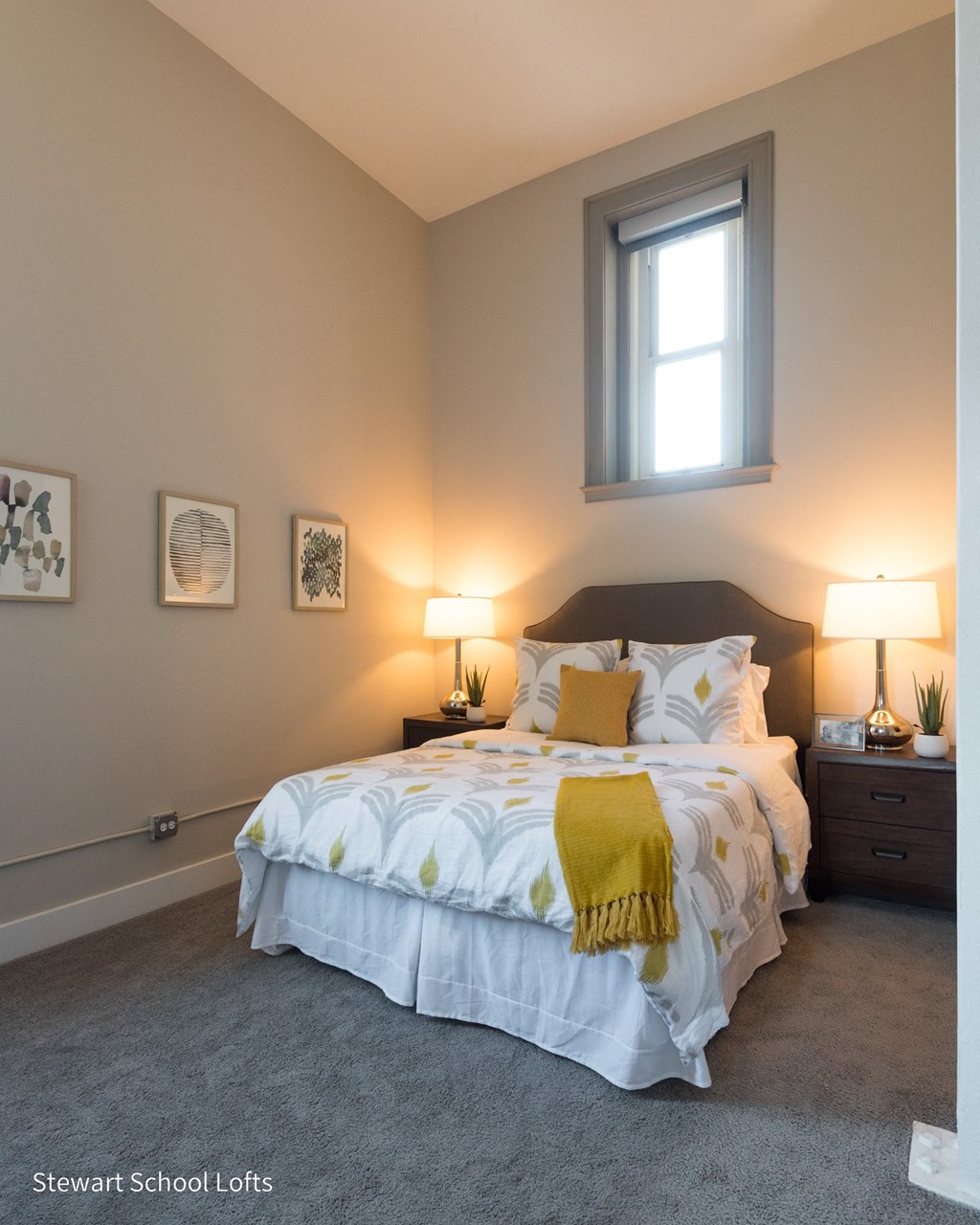 a bedroom with a bed and two night stands and a window