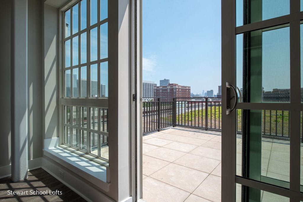 a balcony with a view of the city and a door