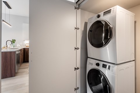 A white washing machine and dryer in a cabinet.