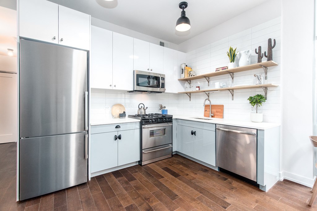 a kitchen with white cabinets and stainless steel appliances