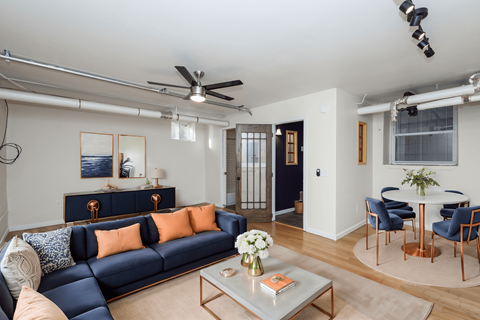 A living room with a blue couch and a coffee table.