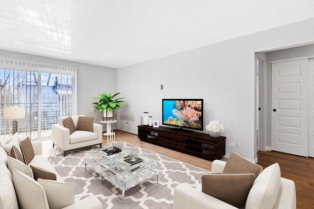 a living room with white furniture and a flatscreen tv