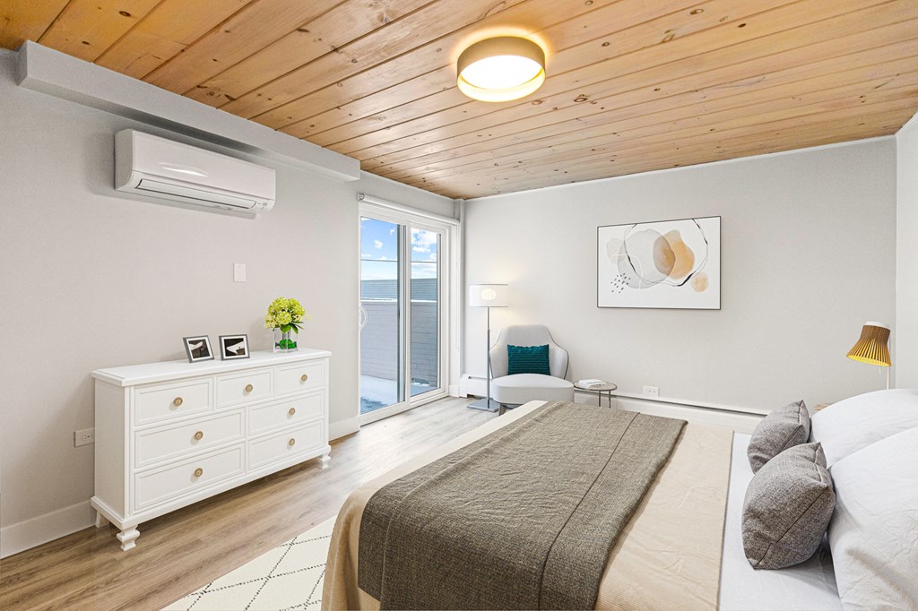 a bedroom with a bed and a white dresser