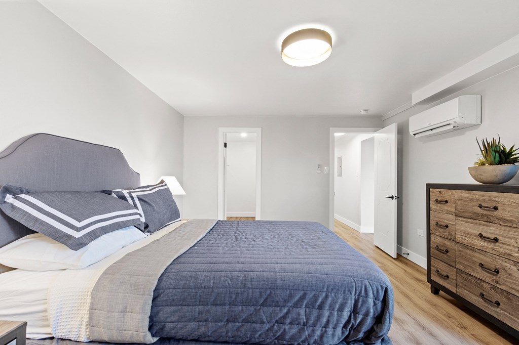 a bedroom with a bed and a dresser