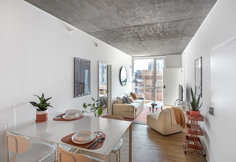 A modern living room with a dining table and chairs.