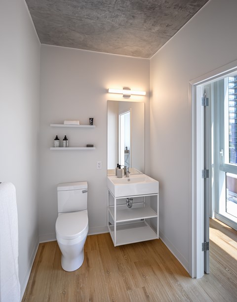 A white toilet and sink in a small bathroom.