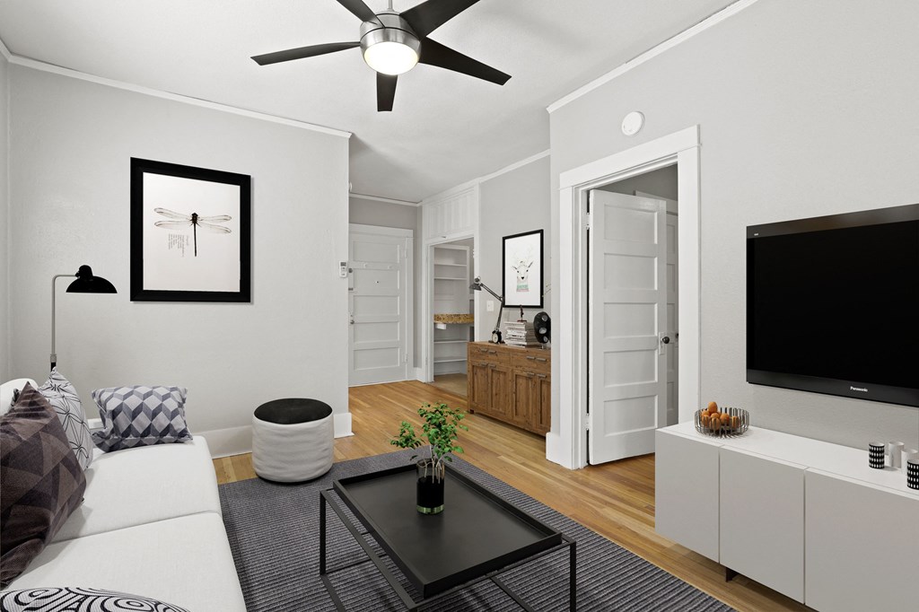 a living room with a white couch and a black coffee table