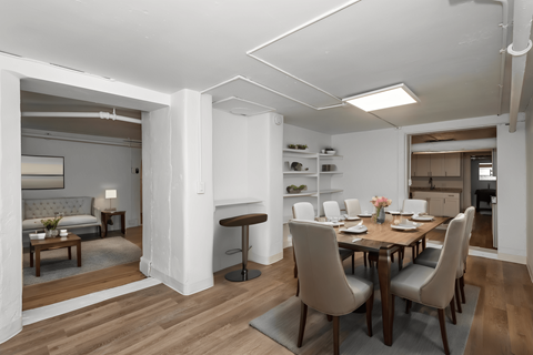 A dining room with a table set for six.