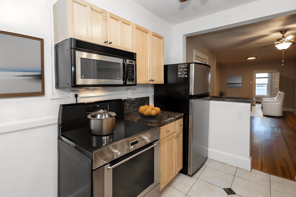 a kitchen with stainless steel appliances and black counter tops