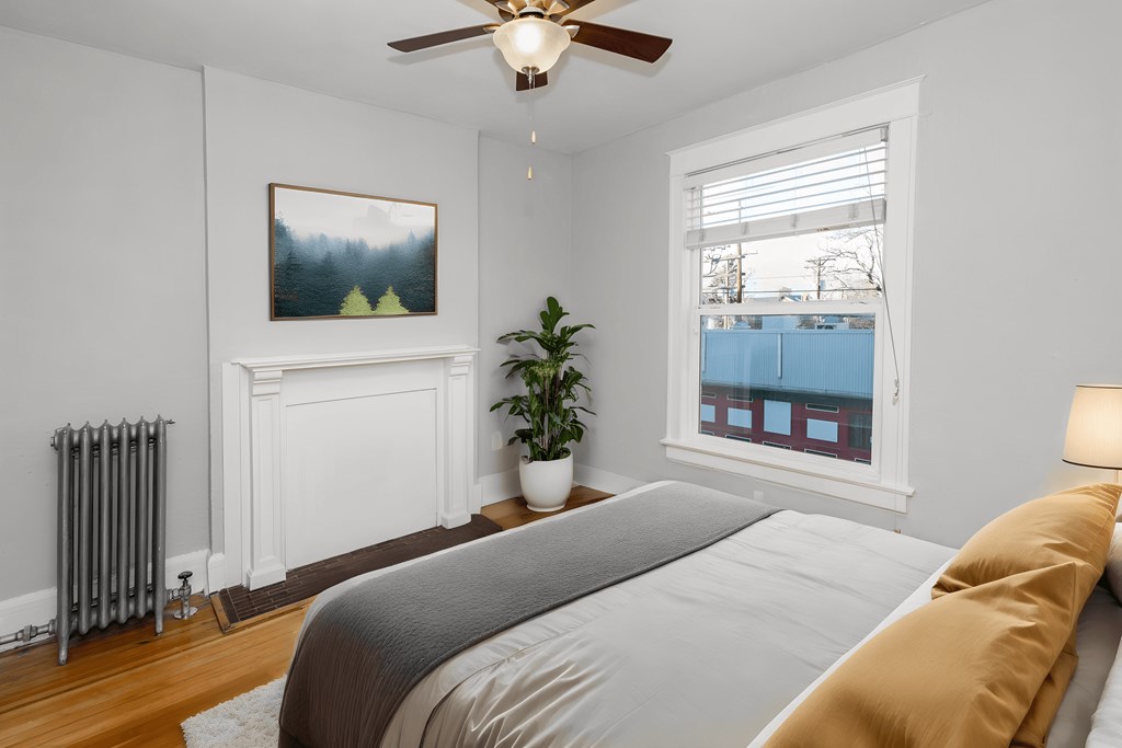 a bedroom with a large bed and a ceiling fan