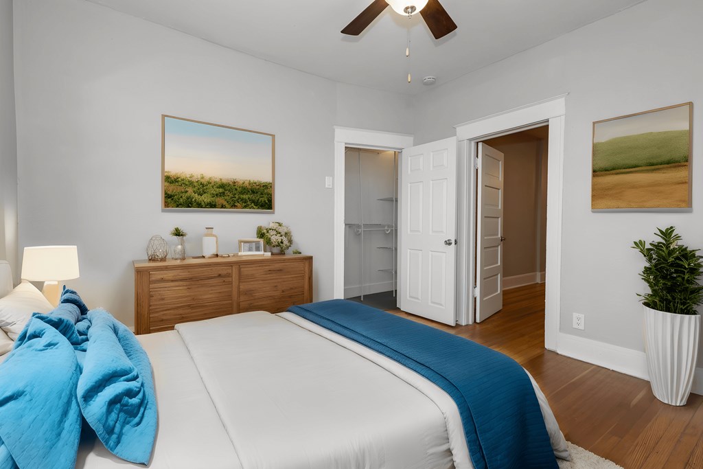 a bedroom with a white bed and a blue blanket