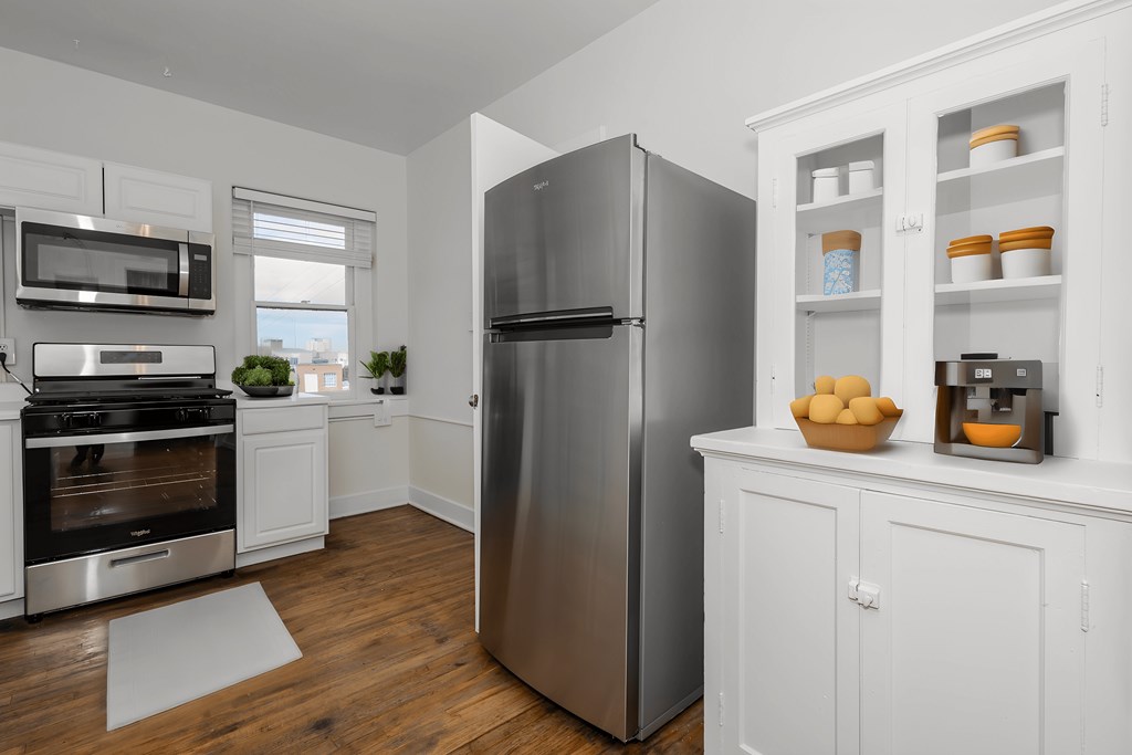 a kitchen with stainless steel appliances and white cabinets