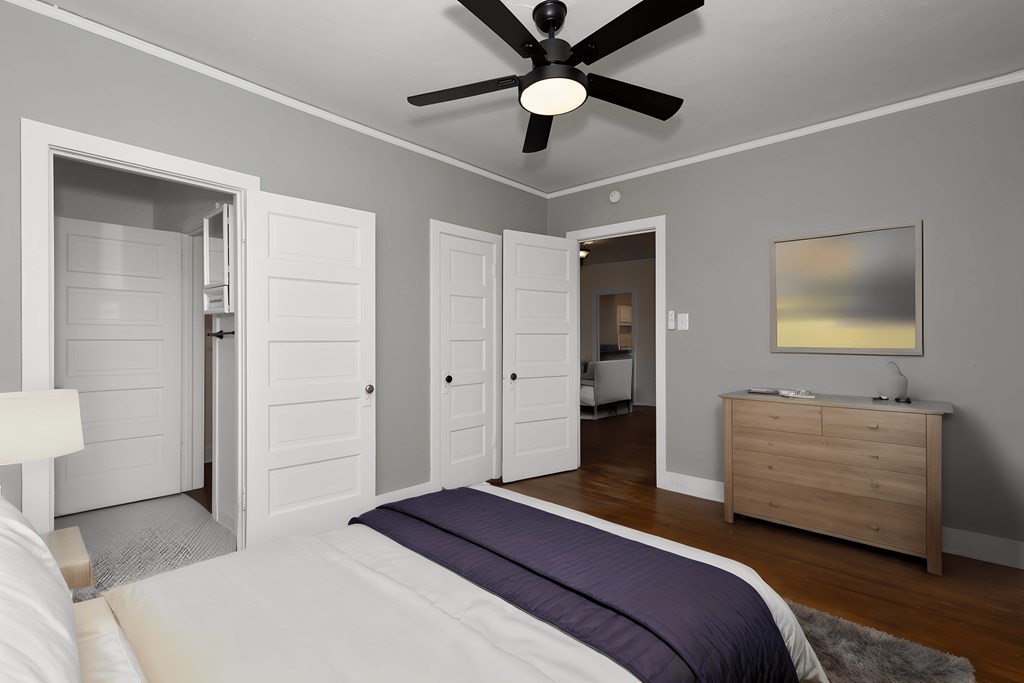 a bedroom with a bed and a ceiling fan