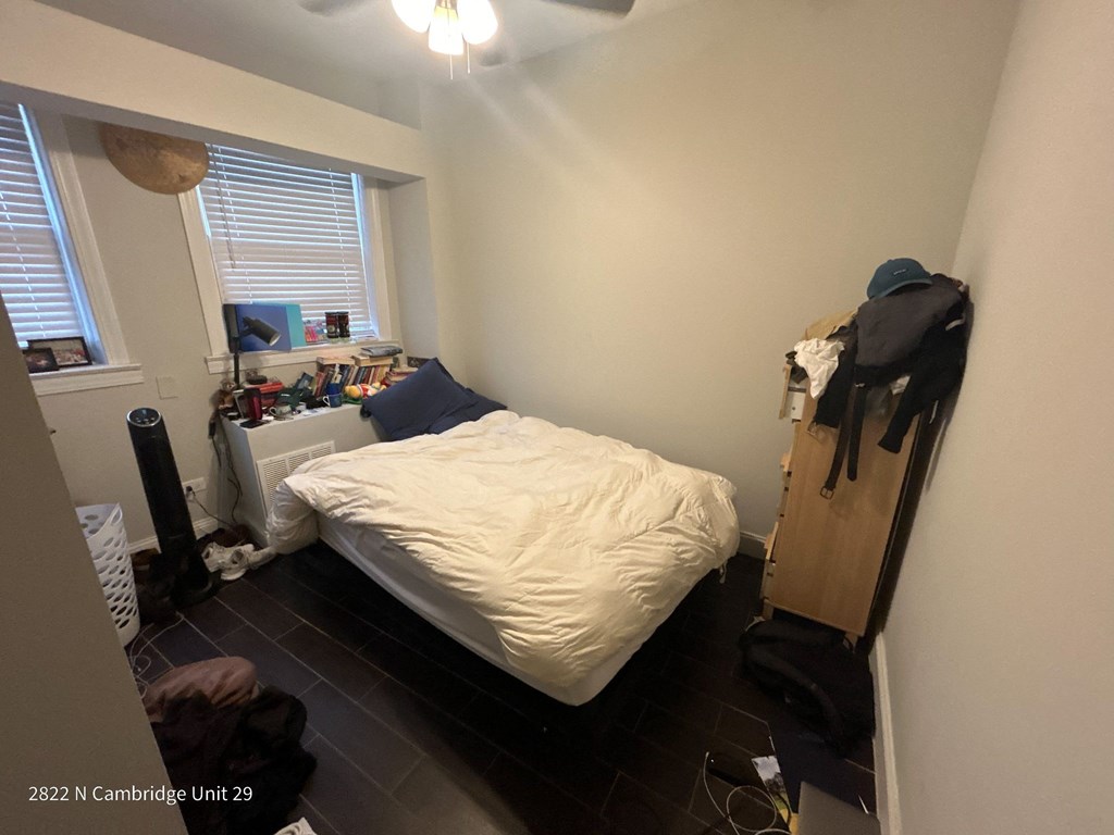 a bedroom with a bed and a dresser and a window