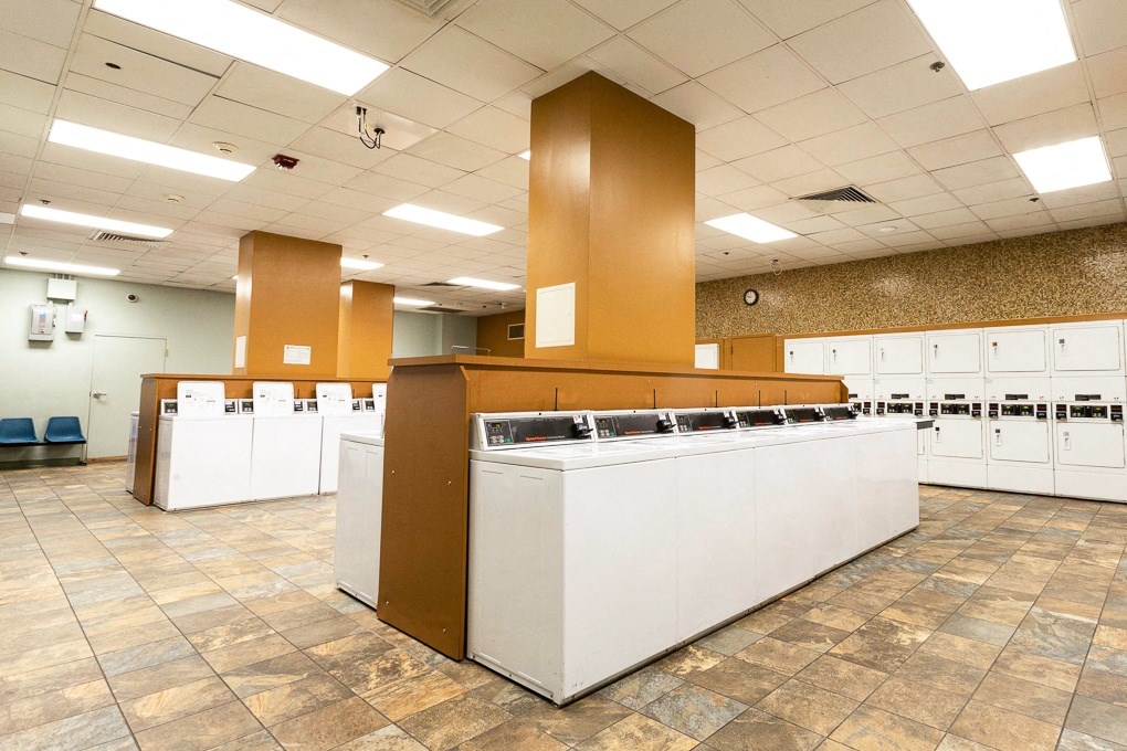 the sinks and counters in a large room with mailboxes