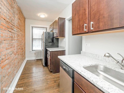 a kitchen with a sink and a refrigerator and a window