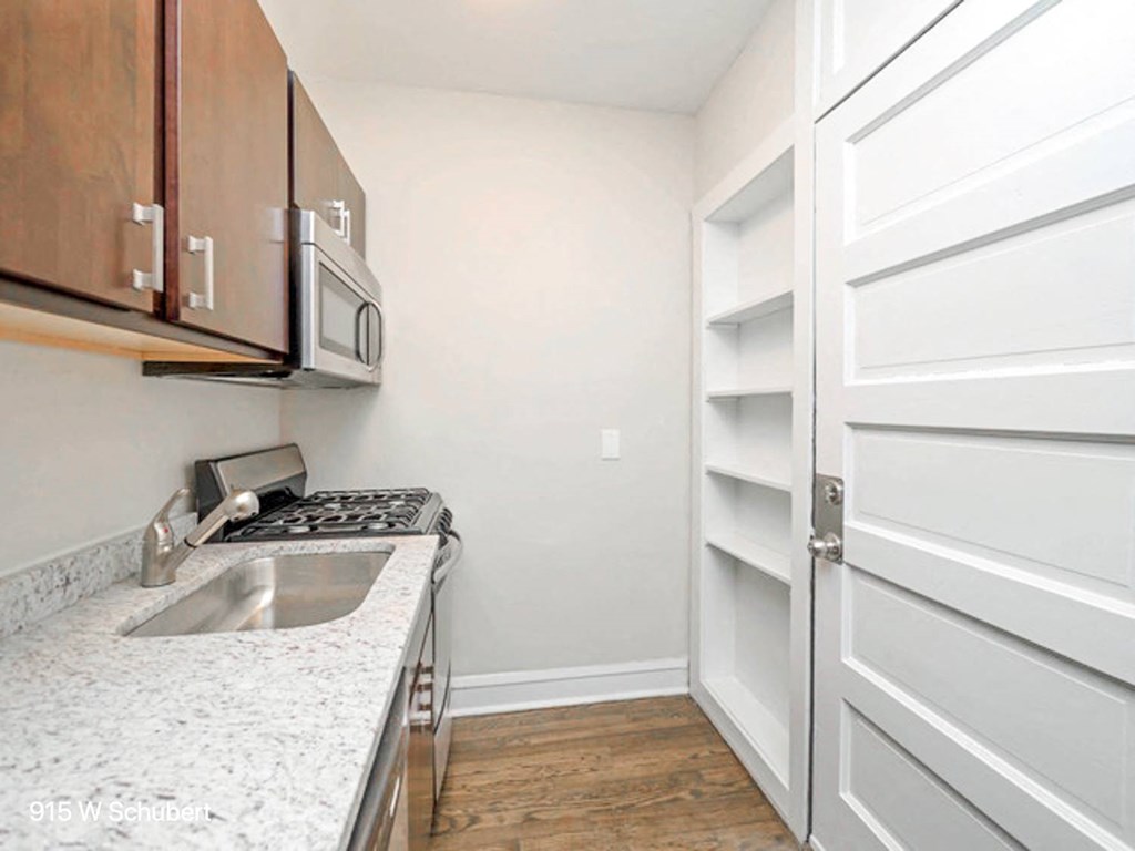 a kitchen with a sink and a white door